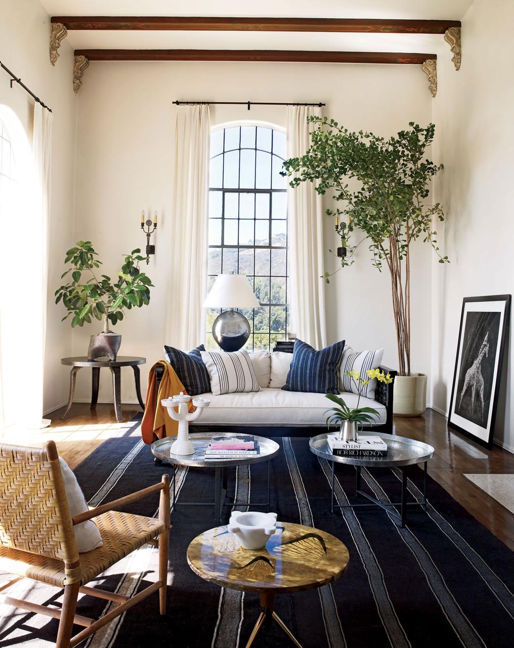 the living room of the home that actress ellen pompeo shares with her husband, chris ivery, and their daughter stella luna includes furnishings both old and new a vintage dhurrie underfoot and a custom made sofa by designer martyn lawrence bullard who decorated the house