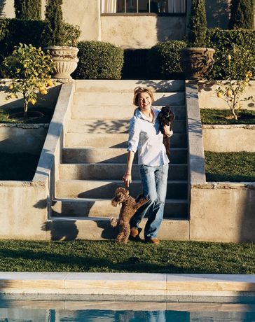 ellen pompeo plays with her toy poodles gigi and valentin, beside the swimming pool at her home in the hollywood hills