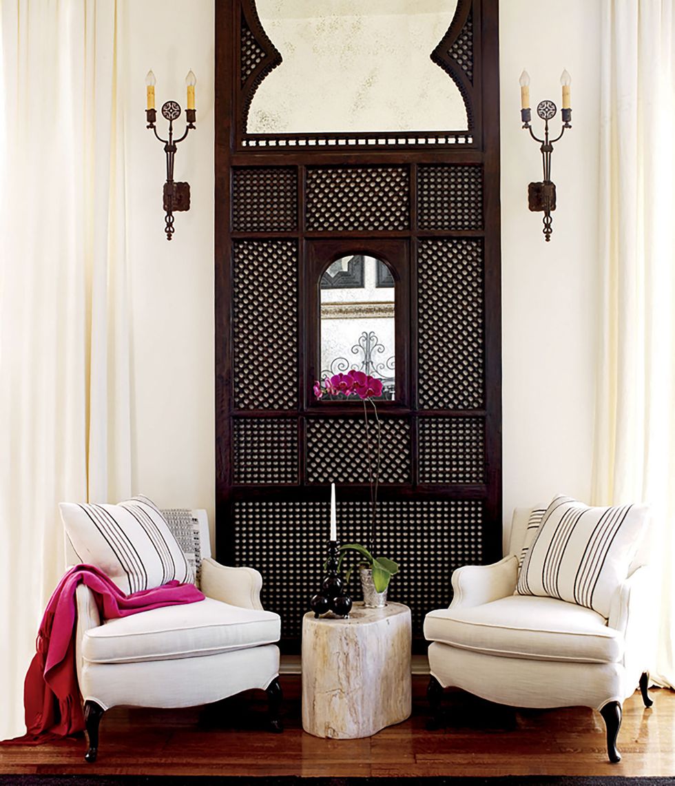 the living room chairs were left by the previous owners and a petrified wood block from dao home serves as a side table