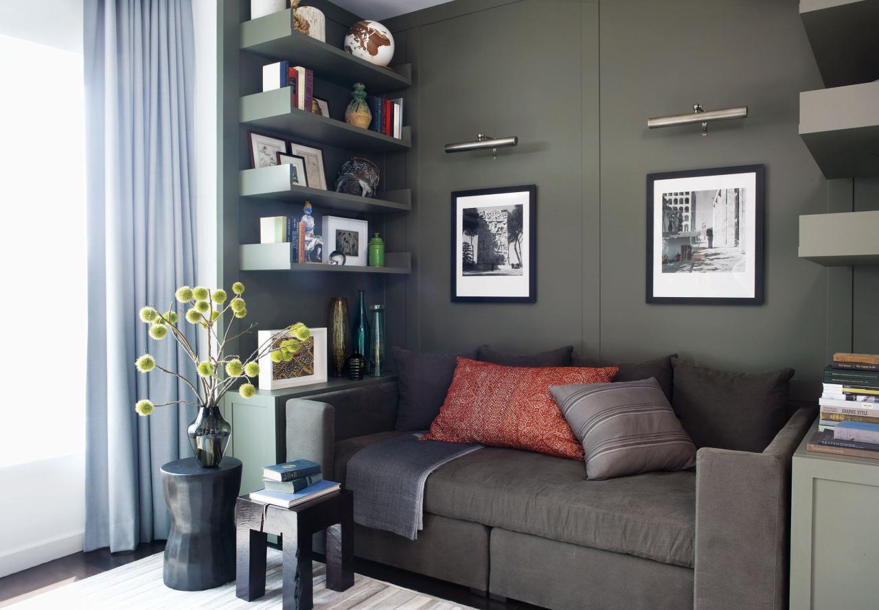 in the study a calvin klein home sofa is topped with vintage moroccan pillows the stools are by tucker robbins left and oly and the light fixtures are from circa lighting the custom made paneling and shelves are painted in benjamin moored dark olive