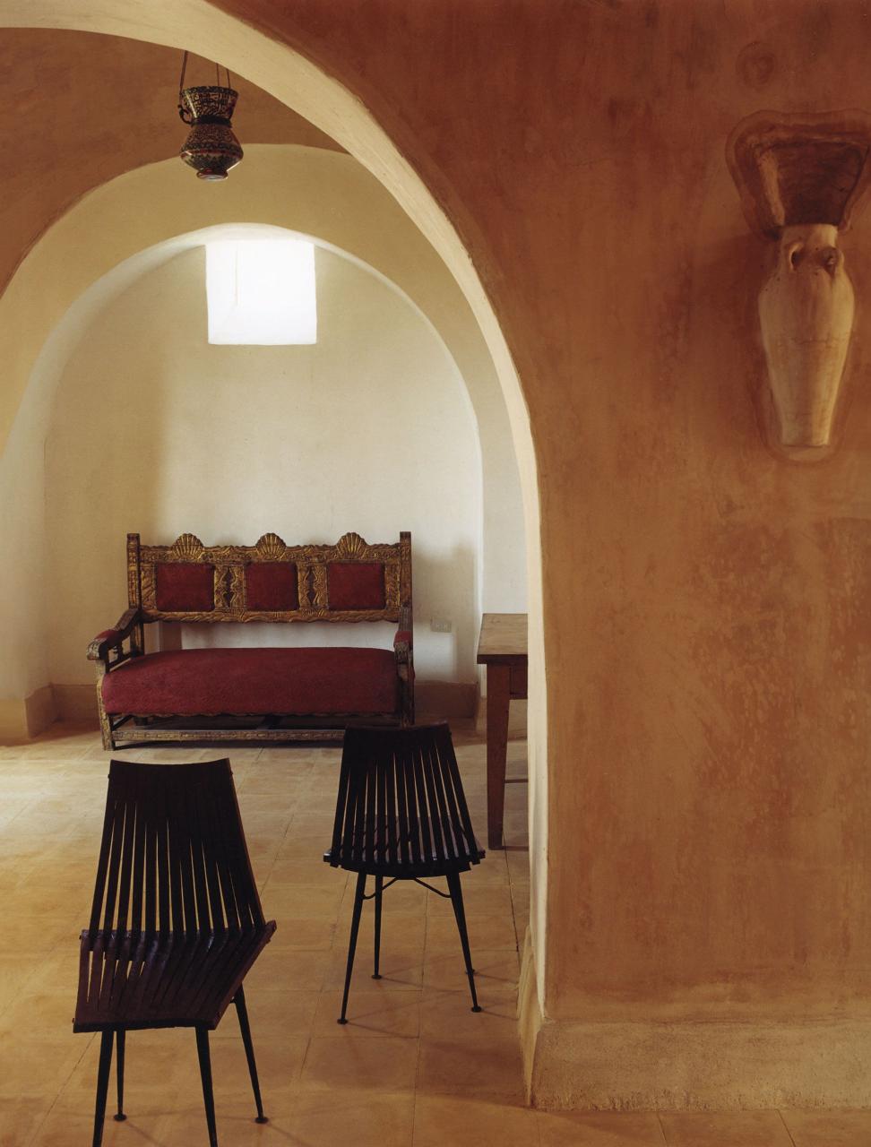 an antique sofa in an alcove off the dining room