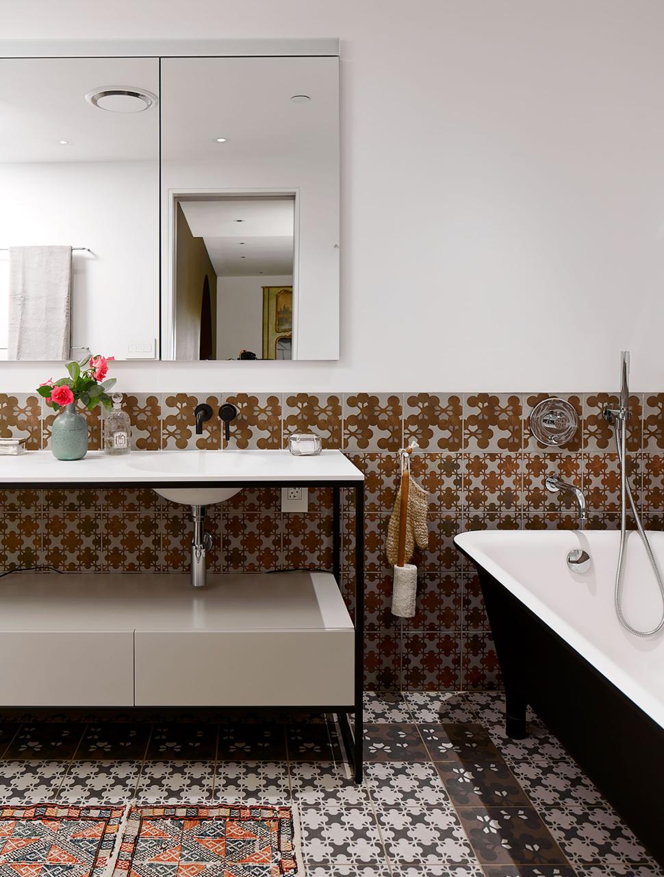 a bathroom with a tub sink and a mirror